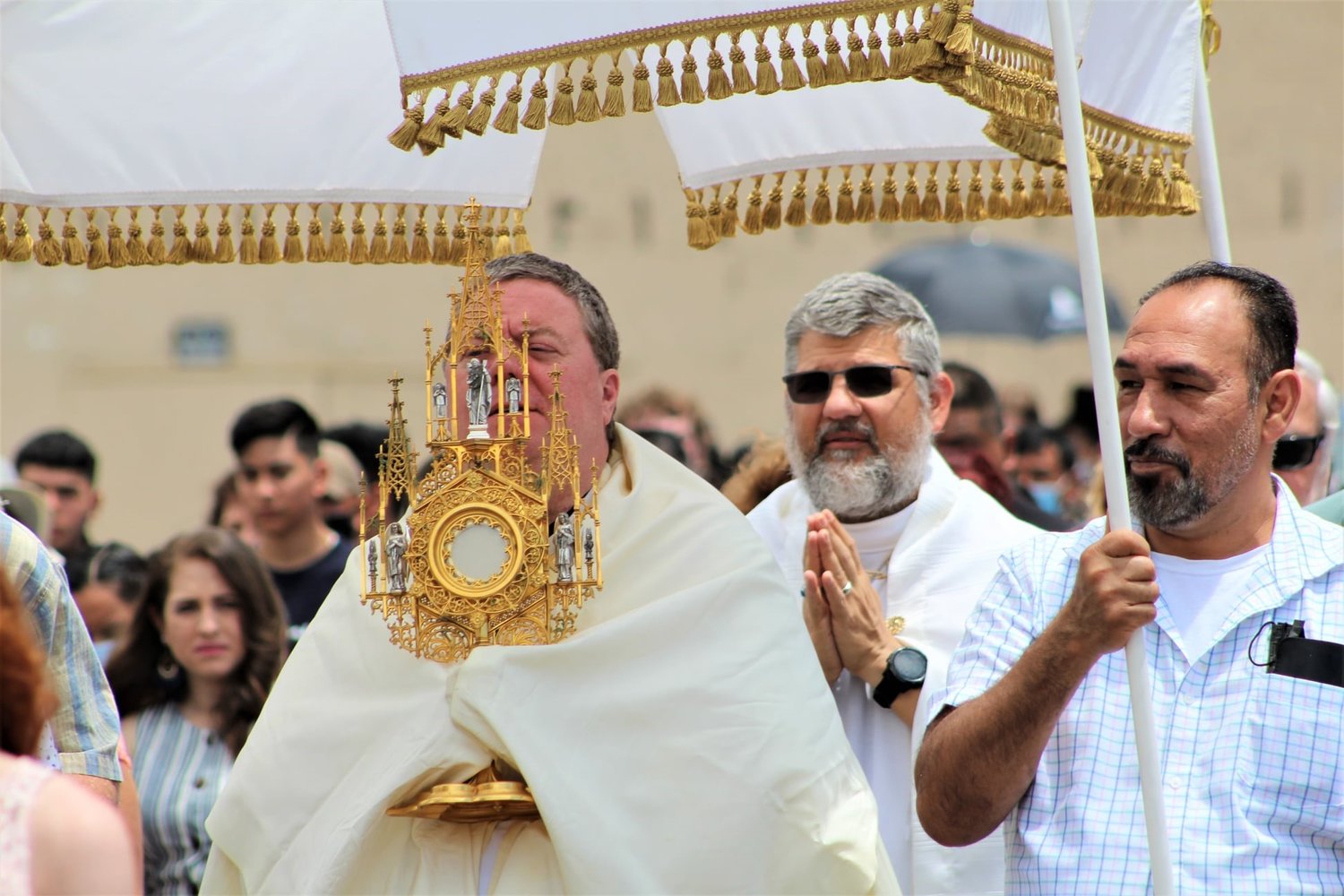 Father Joseph Corel, followed by Father David Veit, carries the Most Blessed Sacrament in procession on a past year's Solemnity of the Most Holy Body and Blood of Christ (Corpus Christi) in Sedalia.
